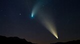 Two bright comets grace the night sky above a dark landscape