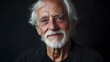 © JorgeL - Portrait of senior man with grey hair and beard looking at camera isolated on dark background studio shot