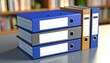© skdesign - Organized office binders stacked on a table showcasing various colors and blank labeled spines