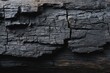 © Stock by Hemal - High-quality photo of burnt wooden texture background. Rough black wood surface caused by burning fire. Dark material made from coal or charcoal.