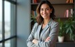© fu - Confident leader smiling latin hispanic, middle eastern business woman standing arms crossed in office looking at camera. Portrait of middle age manager adult executive CEO entrepreneur businesswoman
