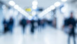 © al-sultan - Blurred people walking through a bright indoor hallway filled with soft light, creating a lively yet gentle atmosphere that conveys movement and openness.