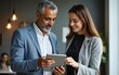 © fu - Mature 40s years old man, young adult woman employee discussing project on digital pc tablet computer. Successful middle aged latin hispanic businessman, businesswoman work together on business plan