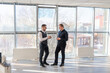 © Михаил Решетников - Two Caucasian men talking at work in the office.
