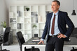 © Pixel-Shot - Portrait of handsome mature businessman in light office