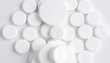 © thonnam - White Pills Arranged Neatly on Pure White Background Creating a Minimalist and Clean Aesthetic Appeal