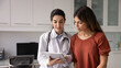 © fizkes - Optimistic young Hispanic doctor woman showing medical report on tablet to female patient sitting on couch, telling checkup result, giving prescription, treatment advice. Banner shot