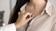 © fizkes - Female medical worker examining young patient, applying stethoscope to chest for checking heartbeat rate, breathing, lungs work. Woman visiting practitioner doctor for examination. Cropped shot