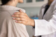 © fizkes - Supportive hand of healthcare professional woman touching shoulder of patient, motivating for treatment, getting better, giving psychological support, compassion. Cropped close up shot