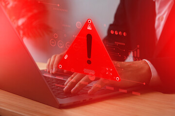 Wall Mural - cyber security risk. businessman typing on laptop with red warning alert sign, hacking threat, malwa