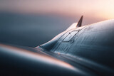 Closeup shot showcasing aircraft fuselage with intricate details, rivets, and paneling against a soft gradient sky. Implies technology, engineering, and precision.