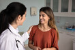 © fizkes - Young optimistic female GP doctor touching shoulder of positive Latin patient woman, giving support, congratulating on good healthcare news after successful treatment, therapy