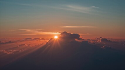 Wall Mural - Aerial capture of the sun setting amidst glowing clouds
