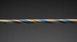 © fabrian - Twisted multicolored cable against a dark gray background