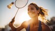 © liliyabatyrova - Young woman enjoys a sunny badminton match while hitting a shuttlecock outdoors