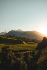 Wall Mural - sunset over rolling hills and mountains