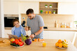 © BGStock72 - Father and daughter prepare a colorful salad together in a bright kitchen