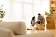 © BGStock72 - Couple unpacking boxes together in a bright living room on a sunny day