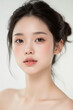 © Eggy - Female Asian Model with Short Hair - Young Beautiful Woman with Hair Bun - Studio Portrait of Asian Beauty for Fashion, Cosmetic, Skincare - Posing on White Background - Smooth Tied Hair