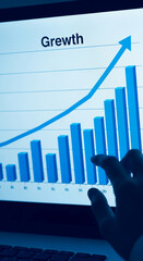 Wall Mural - laptop screen displays upward trending bar graph, indicating growth, hand interacts with the data, s