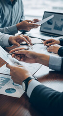 Wall Mural - close-up of hands reviewing financial charts, showcasing business meeting, analysis, and collaborati