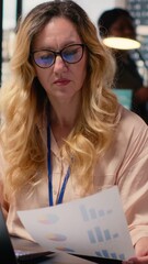 Poster - Vertical Video Ambitious entrepreneur writes a report informed by real time data insights, solving daily tasks at her desk. Strategic thinking and ambition to drive continuous development and progress
