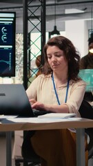 Poster - Vertical Video Businesswoman evaluates key performance metrics and writes reports at her desk, planning financial strategy with her analytical mindset. Professional leadership in business activity