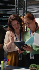 Poster - Vertical Video Strong diverse team of women works together on project analysis and finance reports in a modern corporate office, showcasing determination, efficiency and the power of networking