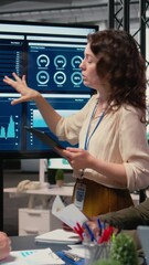 Poster - Vertical Video Businesswomen in a meeting symbolizing productivity in modern office, reviewing analytics in order to refine company vision and objectives. Professionalism and corporate feminism