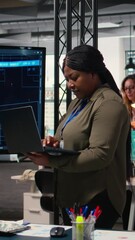 Poster - Vertical Video Black determined leader using artificial intelligence and neural networks to analyze forecast trends in a modern IT company office. Automation for business strategy optimization. Camera