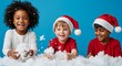 © Lerivan - Three happy children in Santa hats play with snow on a festive, blue background.