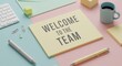 © Firman Dasmir - Pastel toned Welcome to the Team message displayed on vibrant office stationery