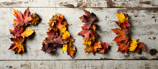 Wall Mural - autumn leaves forming the word fall on a wooden board against a white background seasonal concept fo