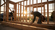 © delila - Skilled Rooftop Carpenter Team Working on New Home Frame at Sunset