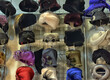 © Evdoha - A display case with women's hats and headwear of various styles and colors.