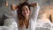 © 沈军 贡 - A young woman stretches in bed, waking up in the morning with a smile, feeling relaxed and content.