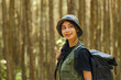 © Dimas - A woman wearing a blue and white hat. She is smiling. She is wearing a green vest