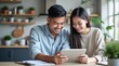 © Tonton1541 - personal finance insurance control  concept Happy couple enjoying a digital device together at home.