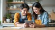 © Tonton1541 - personal finance insurance control  concept Cheerful couple enjoying time together while using a tablet.