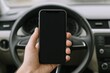 © Generative AI - Smartphone Display in Car: Hand Holding Device Against Steering Wheel For Transportation Mockup