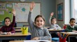 © Iuliia - Young cute schoolgirl raising hand to answer question from teacher in classroom. Happy kid elementary student learning while sitting at desk during lesson. Education, knowledge, back to school concept
