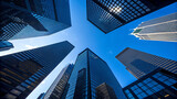 Looking up at modern skyscrapers in the financial district on a sunny day