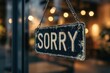 © Kahartakhassus - A weathered 'Sorry' sign hangs from a shop's door