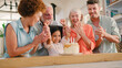 © Monkey Business - Multi-Generation Family Celebrating Granddaughter's Birthday At Home With Cake