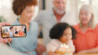 © Monkey Business - Dad Takes Photo As Multi-Generation Family Celebrate Granddaughter's Birthday At Home With Cake