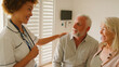 © Monkey Business - Female Nurse Wearing Uniform Giving Senior Couple Good News In Private Hospital Room