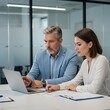 © Taposh - Business professionals collaborating on a laptop in an office meeting
