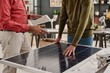 © TrueFrame Collective - Crop shot of unrecognizable male specialists developing new solar panel model at work in office