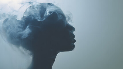 Profile of woman with smoke blending into her head. Conceptual black and white image symbolizing mental overload, anxiety or burnout.