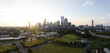 Charlotte, United States - 30 July 2025: Aerial view of a skyline punctuated by the iconic Bank of America Corporate Center and the lush green spaces below.